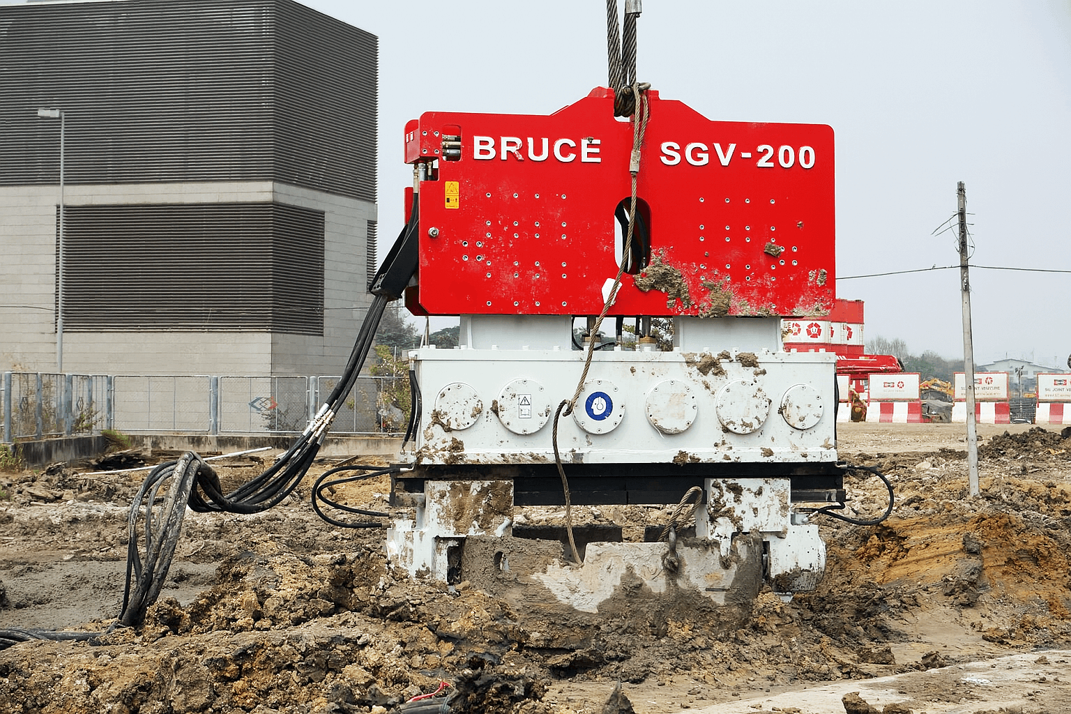Vibro hammer with double hydraulic clamps installed on casing pile