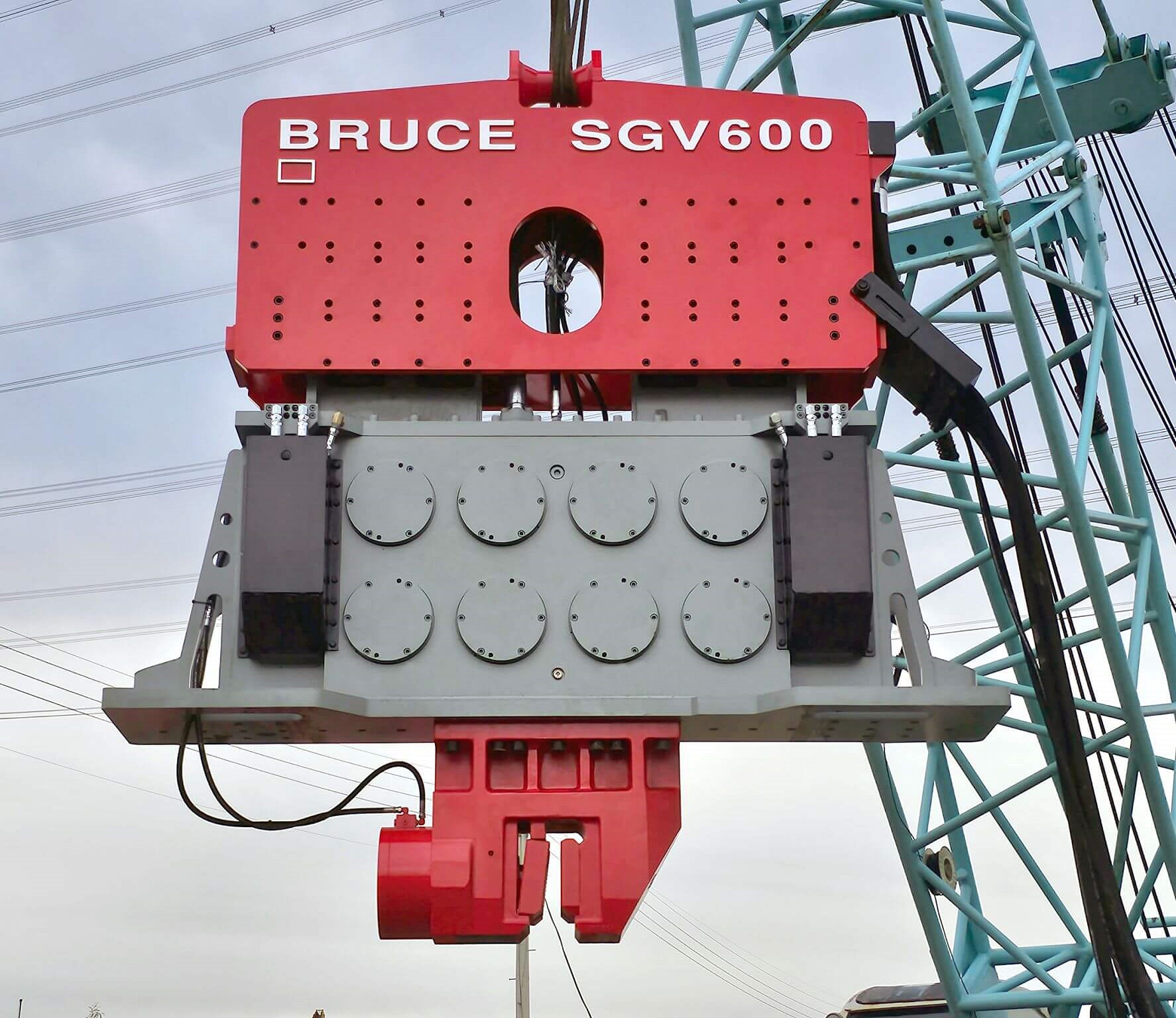 vibratory hammer mounted on crane at construction site