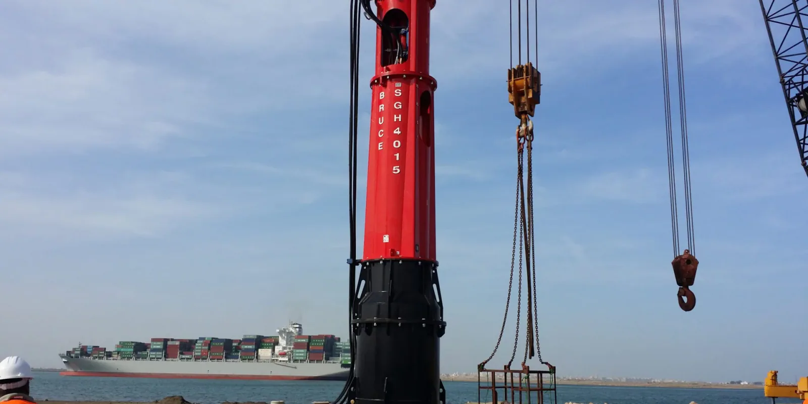 BRUCE hydraulic impact pile hammer at a construction site, shown as possible equipment for a later installation stage